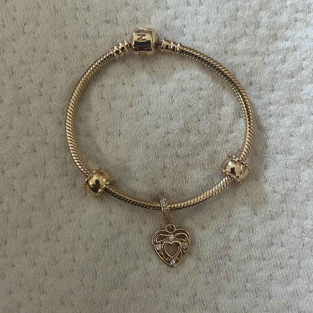 Pandora 14kt gold 6.7” moments bracelet with two clips and a diamond heart charm